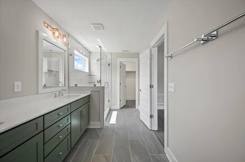 a spacious bathroom with a double vanity sink and a mirror