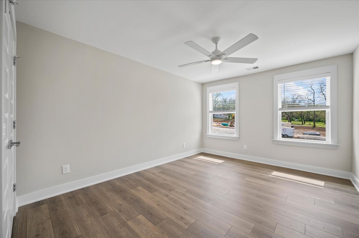 3043 A Hillside Road Nashville, TN 37207 - Photo 18 of 31 an empty room with wooden floor ceiling fan and windows
