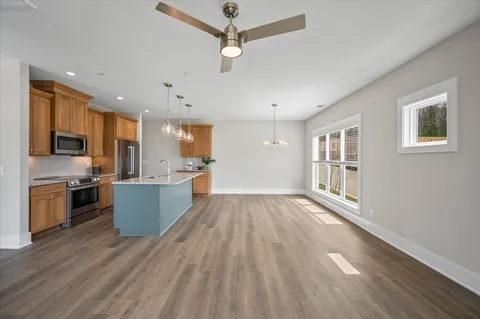 a view of kitchen with sink and wooden floor