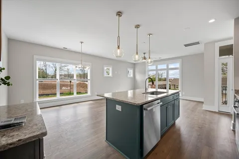 a kitchen with granite countertop a sink and a stove