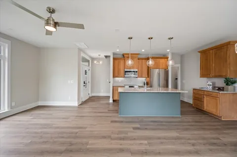 a view of kitchen with cabinets and wooden floor