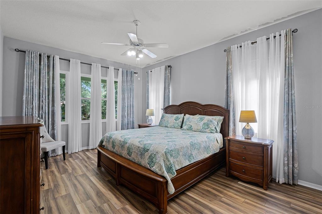 1124 Hidden Bluff Clermont, FL 34711 - Photo 13 of 25 a bedroom with a bed lamp and a window