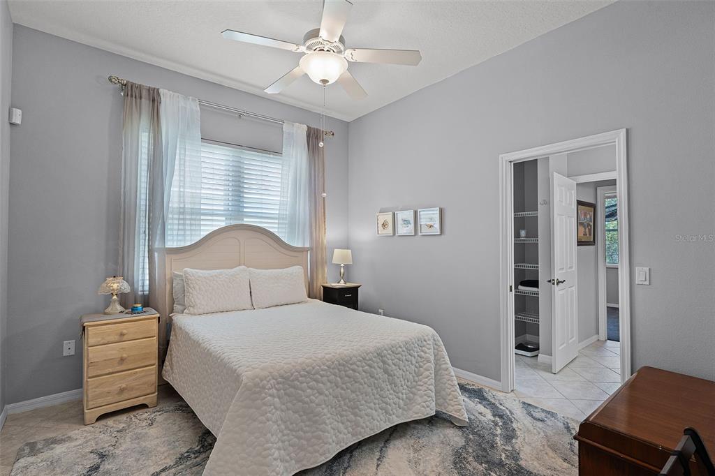 1124 Hidden Bluff Clermont, FL 34711 - Photo 17 of 25 a bedroom with a bed and a chandelier