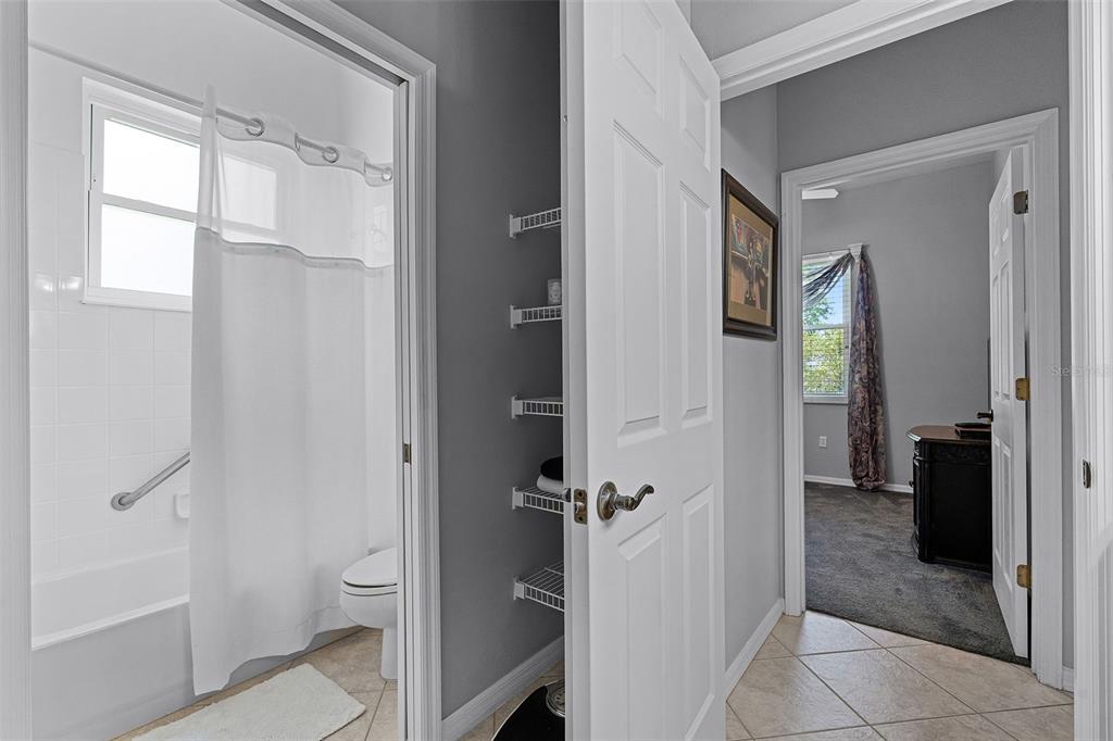 1124 Hidden Bluff Clermont, FL 34711 - Photo 18 of 25 a bathroom with a glass door shower a toilet and a sink