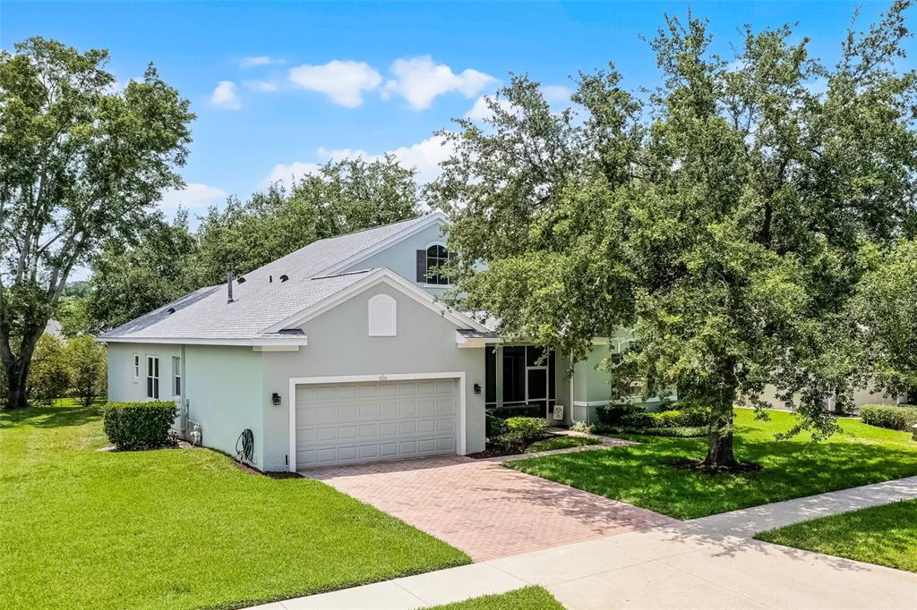 1124 Hidden Bluff Clermont, FL 34711 - Photo 2 of 25 a view of a yard in front of a house with large tree
