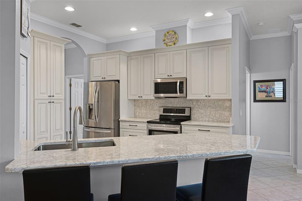 1124 Hidden Bluff Clermont, FL 34711 - Photo 3 of 25 a kitchen with stainless steel appliances granite countertop a stove refrigerator and microwave