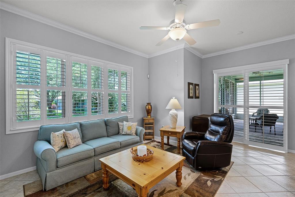 1124 Hidden Bluff Clermont, FL 34711 - Photo 9 of 25 a living room with furniture a table and a large window