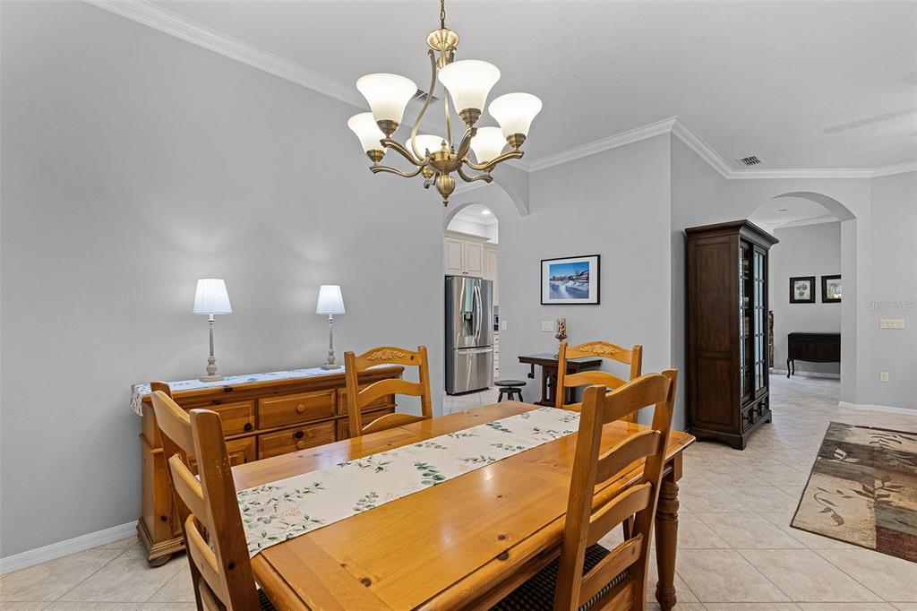1124 Hidden Bluff Clermont, FL 34711 - Photo 10 of 25 a dining room filled chandelier and kitchen view
