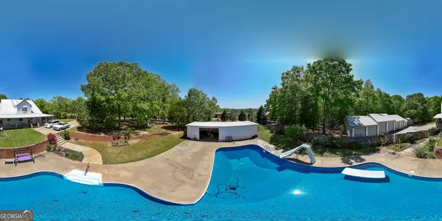 a view of a house with backyard and sitting area