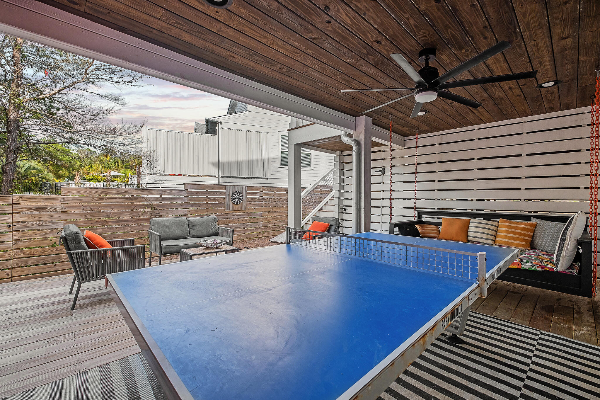 66 Seabreeze Trail Inlet Beach, FL 32461 - Photo 21 of 59 a view of a patio with table and chairs with wooden floor and fence