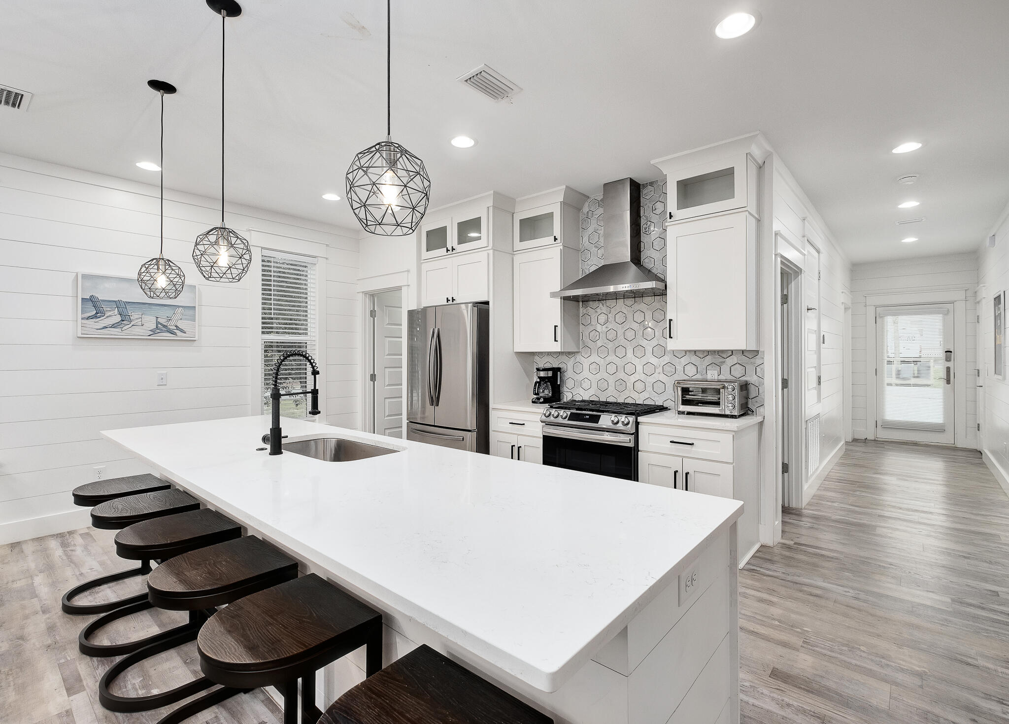66 Seabreeze Trail Inlet Beach, FL 32461 - Photo 6 of 59 a kitchen with stainless steel appliances a chandelier a stove a sink a dining table and chairs