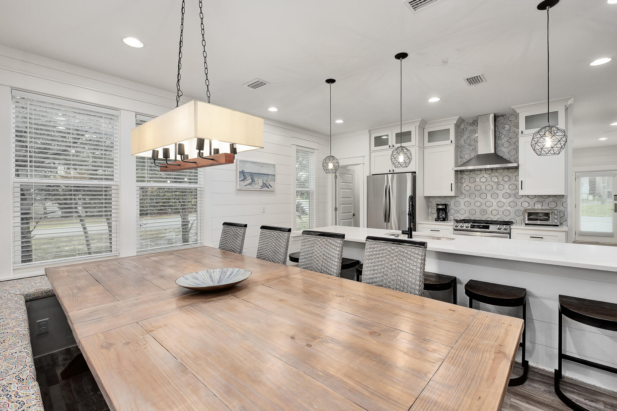 66 Seabreeze Trail Inlet Beach, FL 32461 - Photo 9 of 59 a kitchen with stainless steel appliances kitchen island granite countertop a stove a sink a center island and a wooden floor