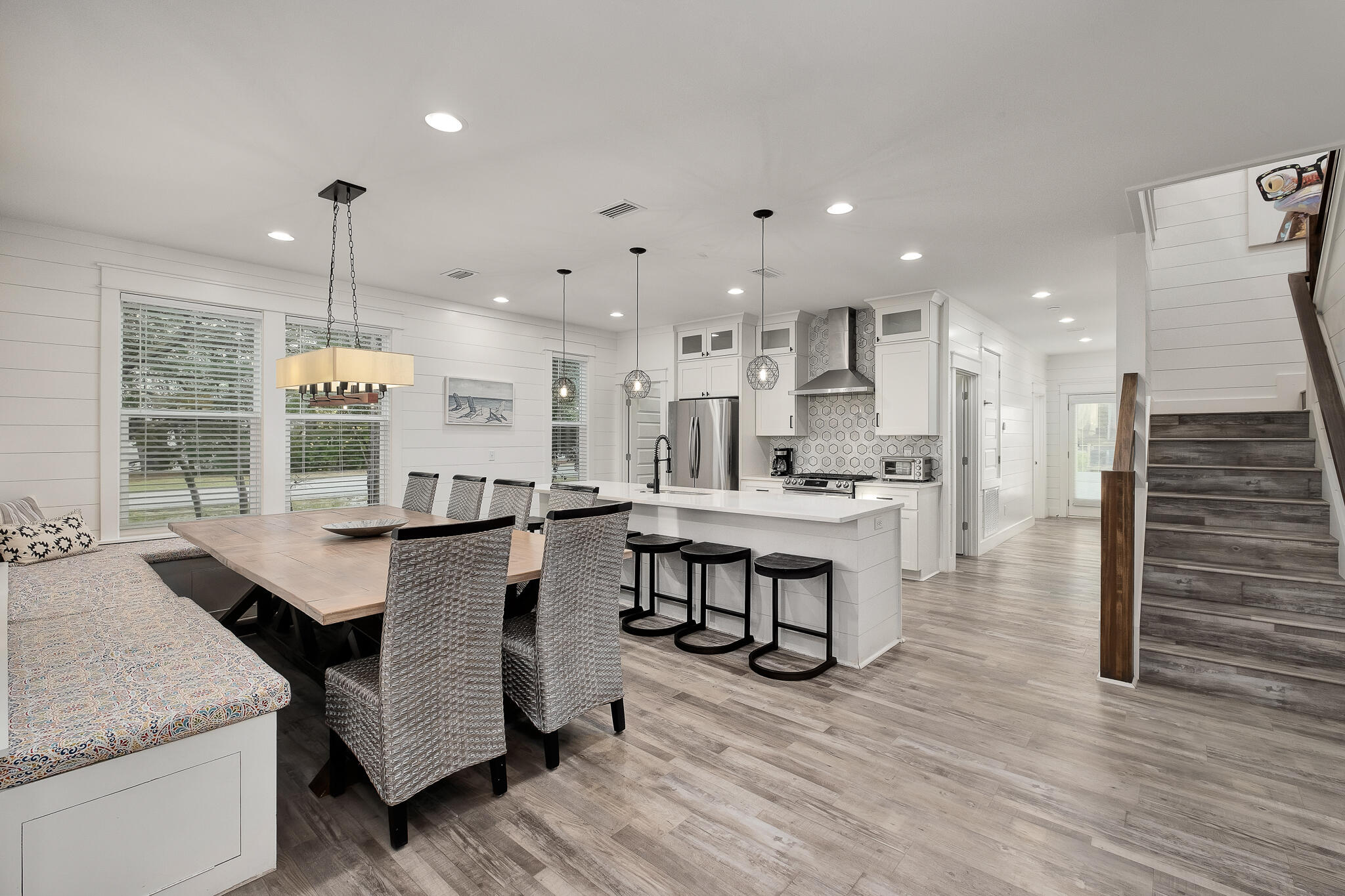 66 Seabreeze Trail Inlet Beach, FL 32461 - Photo 10 of 59 a kitchen with stainless steel appliances granite countertop a stove refrigerator and a dining table with wooden floor