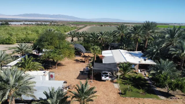 an aerial view of a house with yard and lake view
