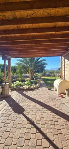 a view of a porch with chairs and potted plants