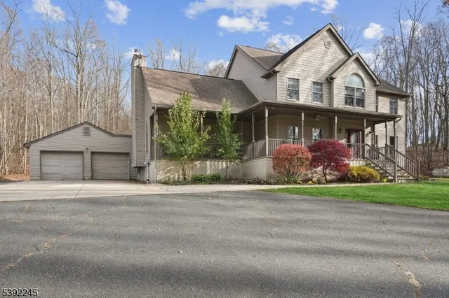 front view of house with a yard and potted plants