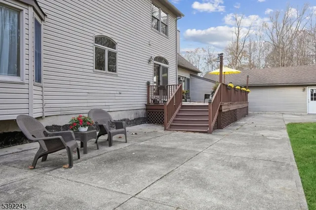 a view of a chairs and table in the back yard of the house