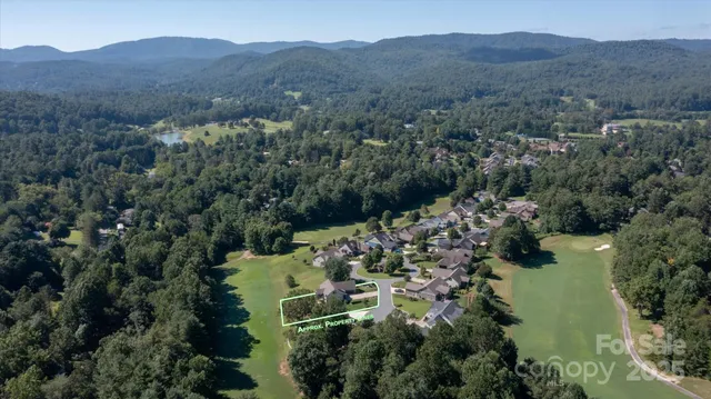 an aerial view of a house with mountain view