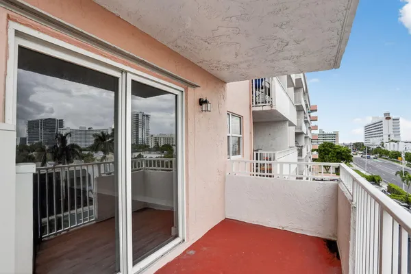 a view of a living room and balcony