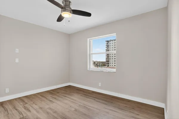 wooden floor in an empty room with a window