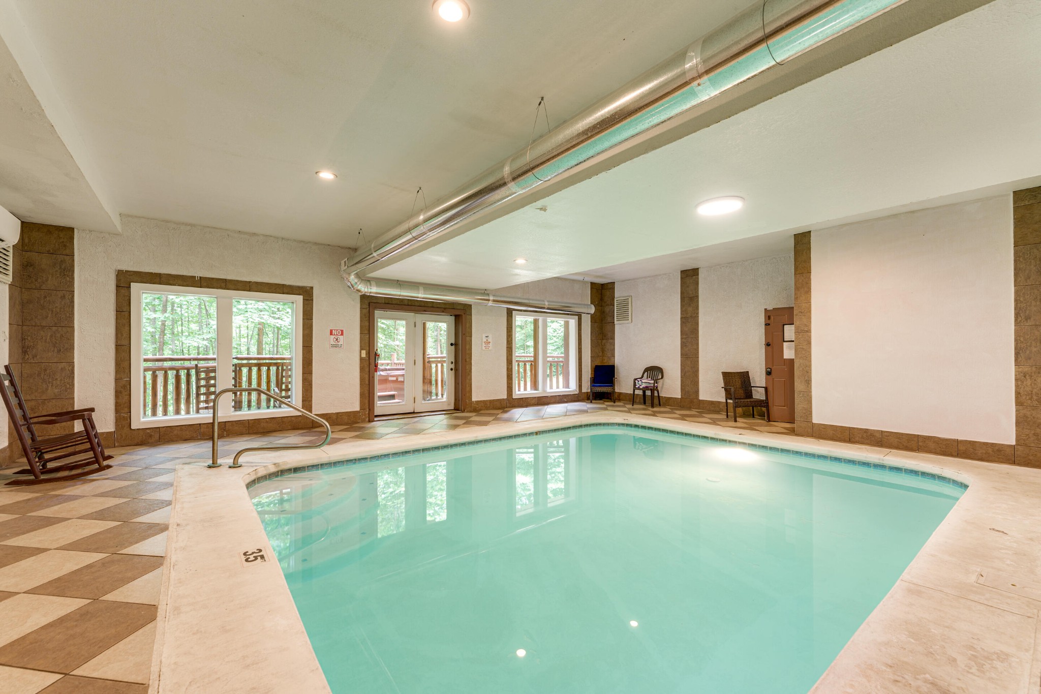 216 Amet Way Cosby, TN 37722 - Photo 14 of 21 a large swimming pool with a large window and couch