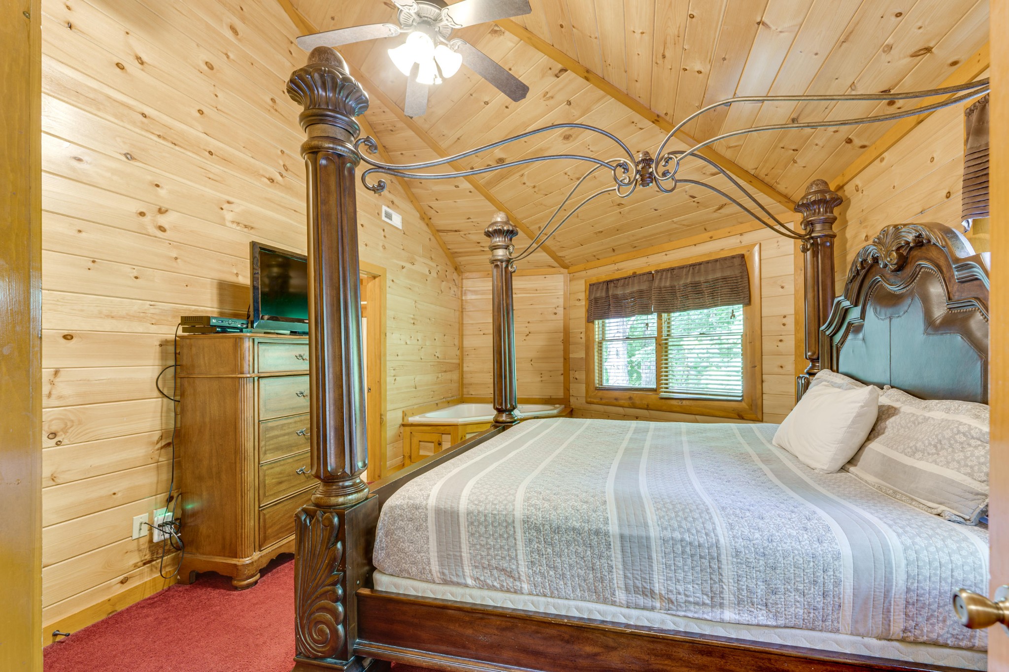 216 Amet Way Cosby, TN 37722 - Photo 10 of 21 a bedroom with a bed and a chandelier