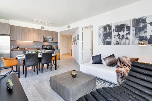 a living room with furniture and wooden floor