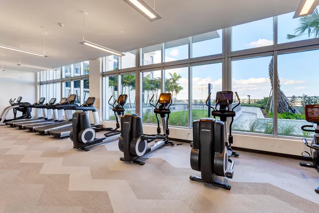 a view of a room with gym equipment and floor to ceiling window