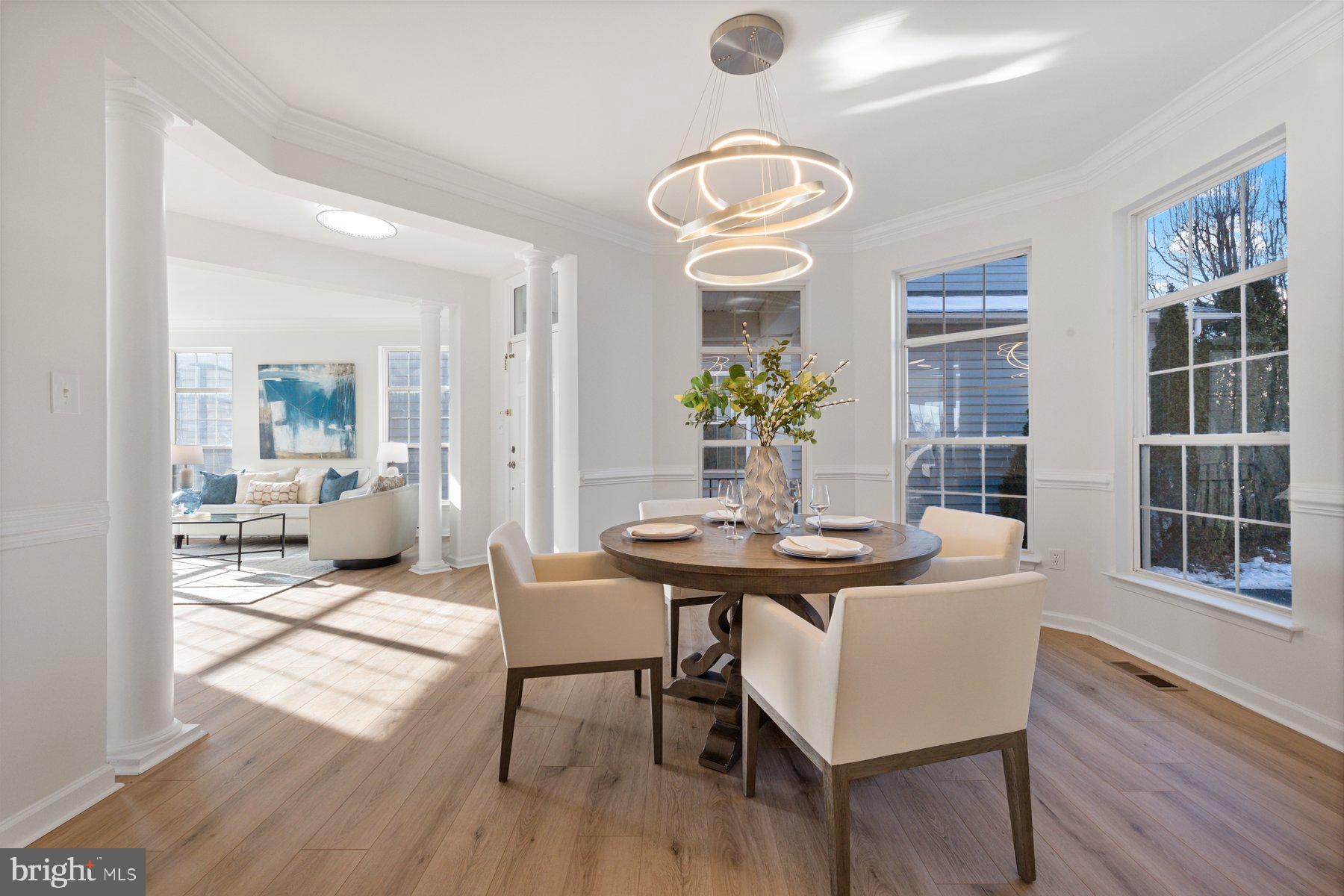 8329 Tillett Loop Manassas, VA 20110 - Photo 12 of 27 a view of a dining room with furniture wooden floor and chandelier