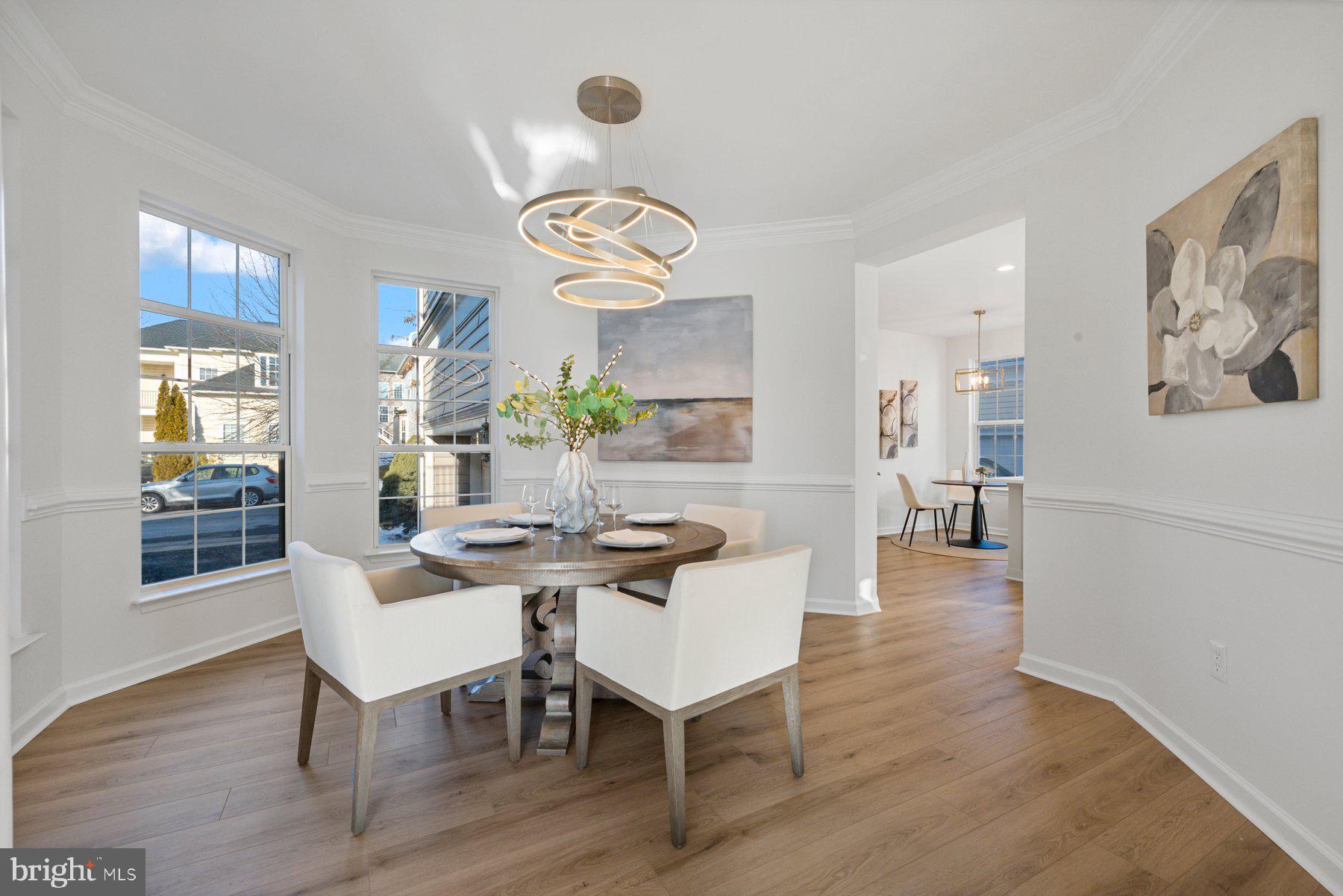 8329 Tillett Loop Manassas, VA 20110 - Photo 13 of 27 a view of a dining room with furniture wooden floor and chandelier