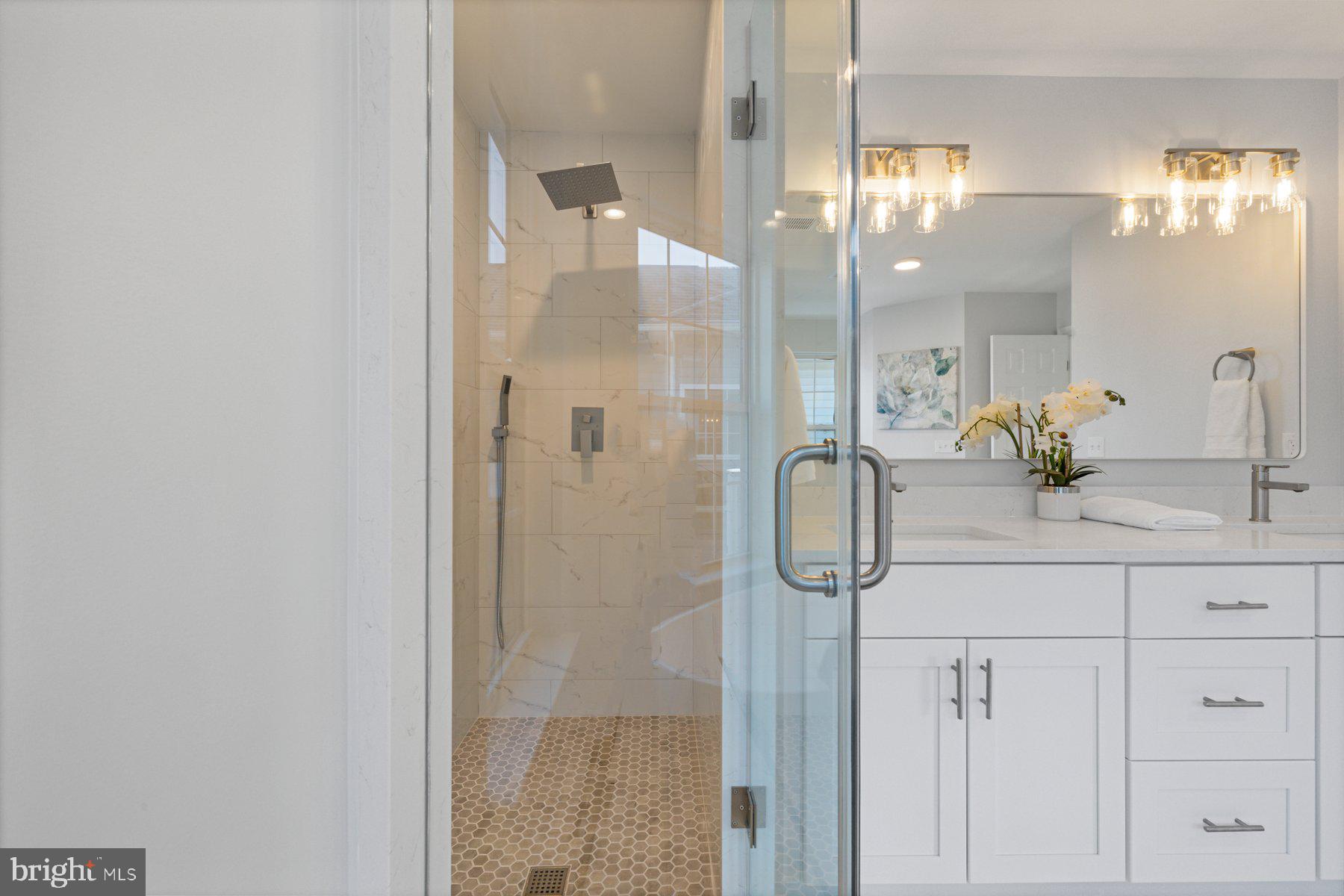 8329 Tillett Loop Manassas, VA 20110 - Photo 17 of 27 a bathroom with a shower and mirror