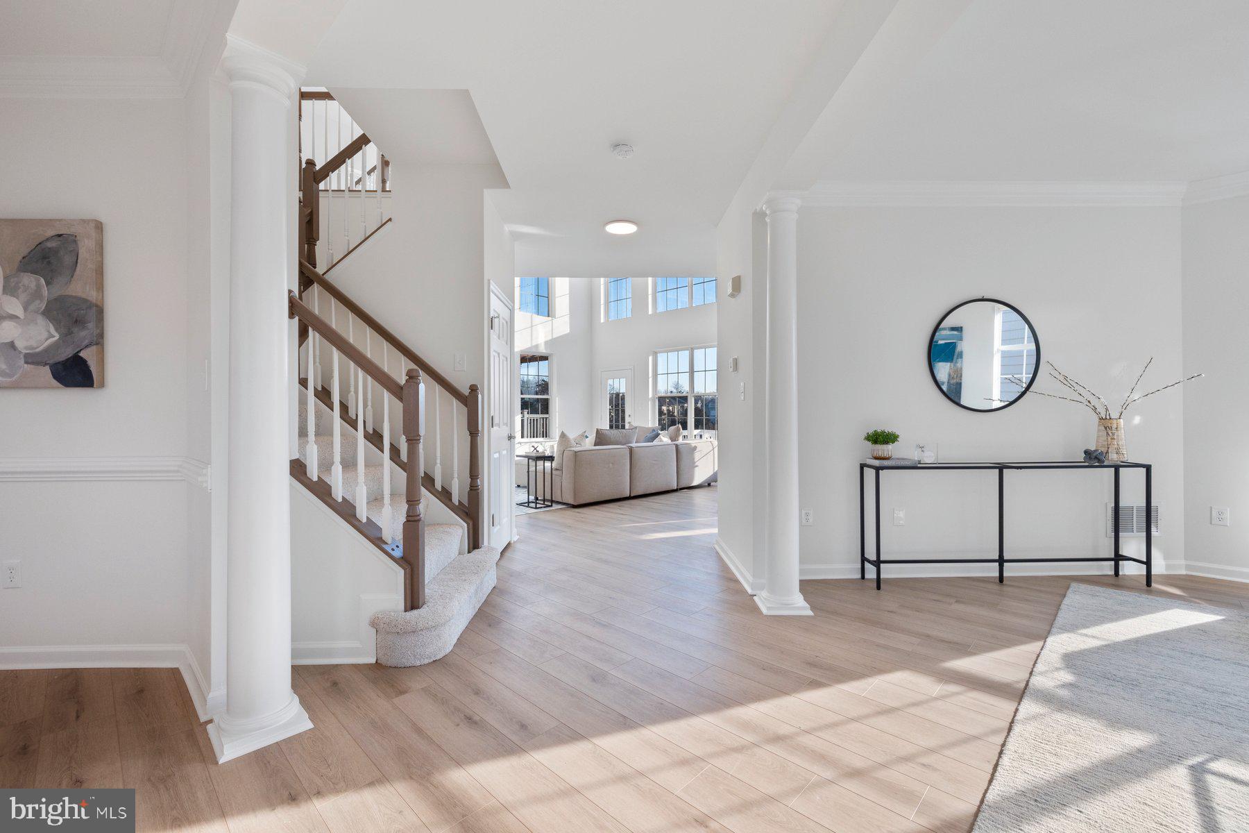 8329 Tillett Loop Manassas, VA 20110 - Photo 2 of 27 a view of a hallway with wooden floor and entryway