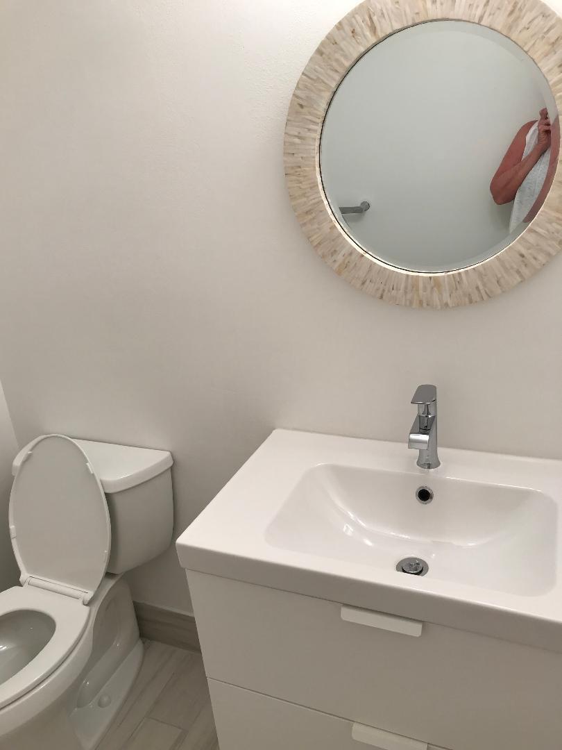 1387 High Point Way Northwest, Unit B Delray Beach, FL 33445 - Photo 13 of 16 a bathroom with a sink and a mirror