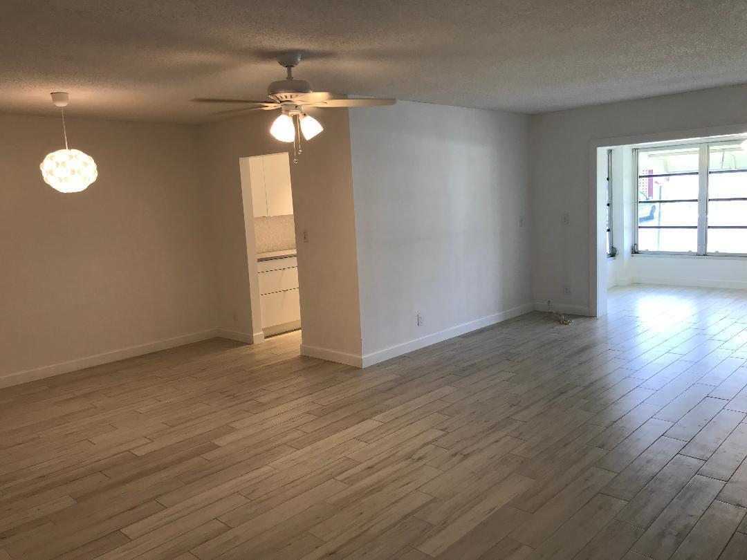 1387 High Point Way Northwest, Unit B Delray Beach, FL 33445 - Photo 2 of 16 a view of empty room with wooden floor and fan