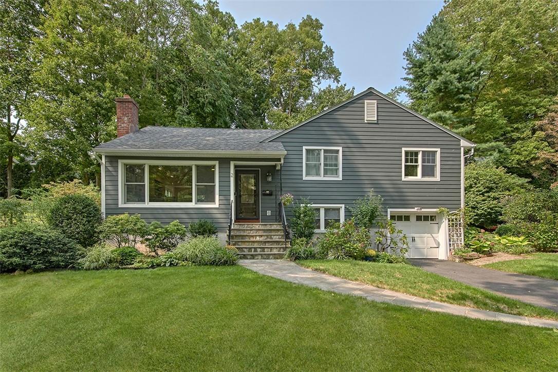 2 Pine Ridge Road Rye Brook, NY 10573 - Photo 1 of 1 a front view of a house with a garden