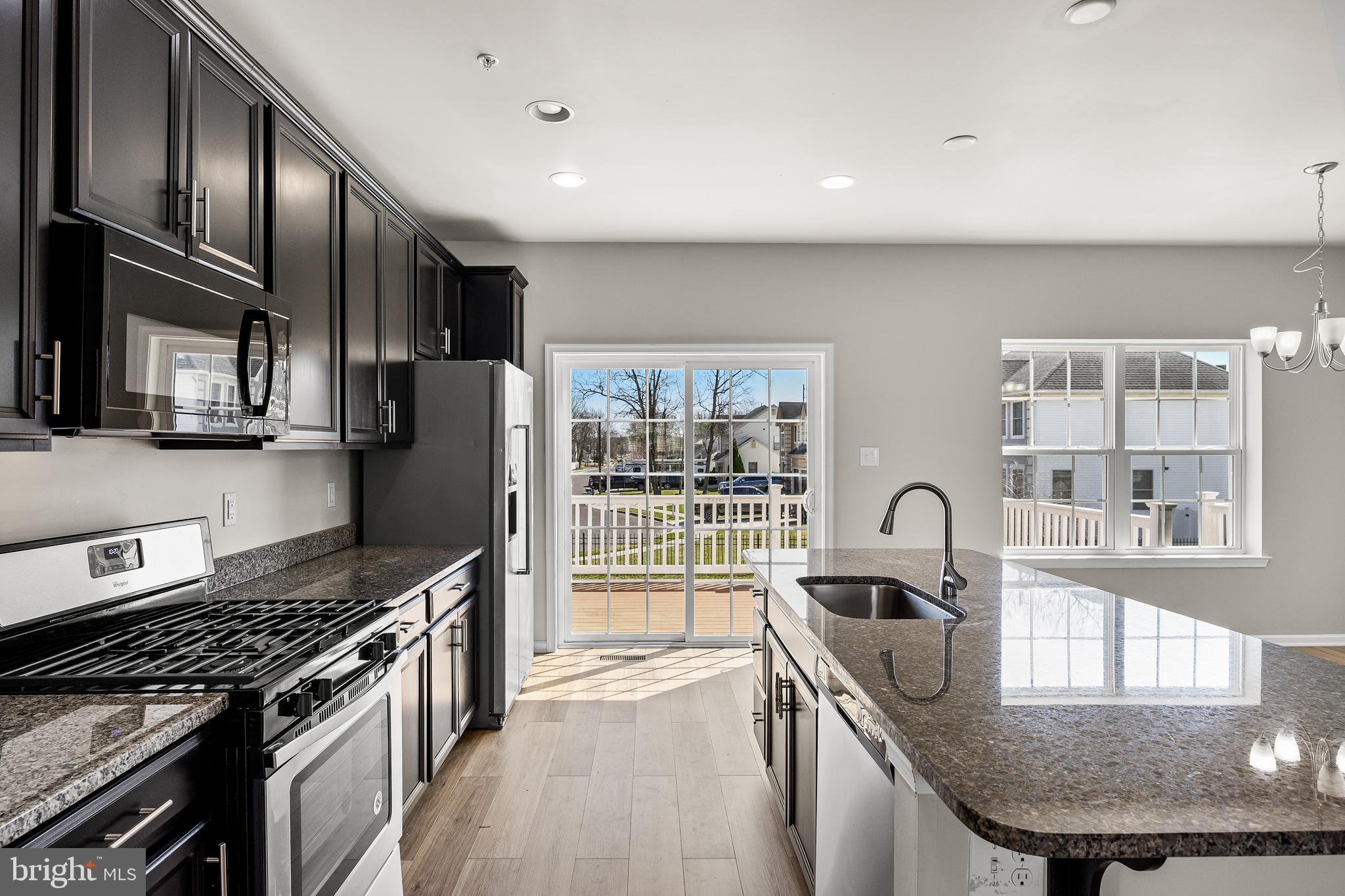 13 Iron Gate Road Sicklerville, NJ 08081 - Photo 11 of 25 a kitchen with granite countertop a stove and a sink