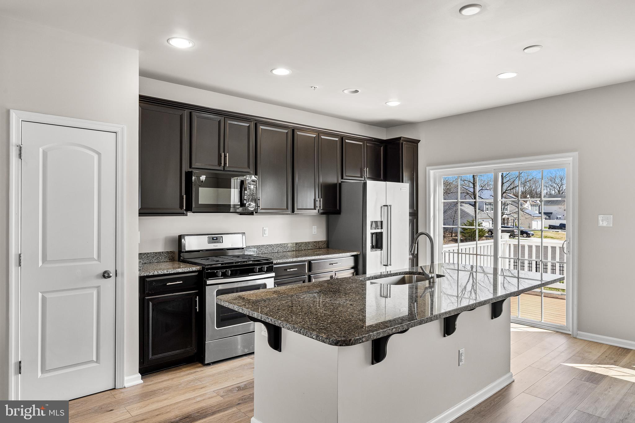13 Iron Gate Road Sicklerville, NJ 08081 - Photo 12 of 25 a kitchen with stainless steel appliances granite countertop a sink stove and refrigerator