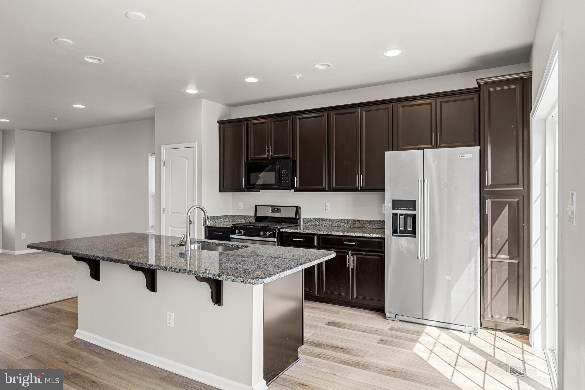 13 Iron Gate Road Sicklerville, NJ 08081 - Photo 13 of 25 a kitchen with kitchen island granite countertop stainless steel appliances and refrigerator