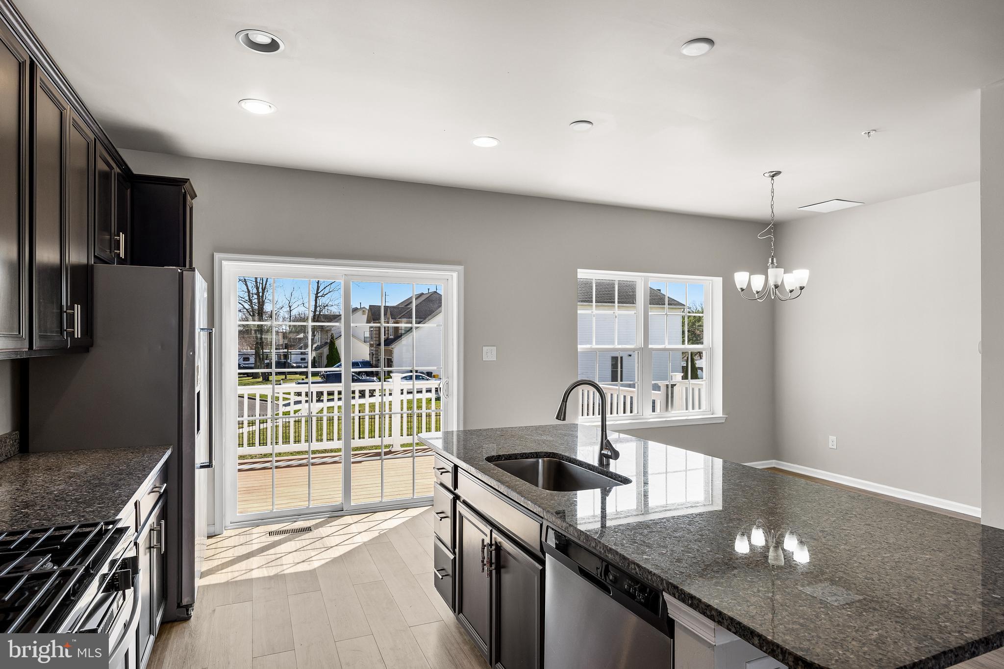 13 Iron Gate Road Sicklerville, NJ 08081 - Photo 15 of 25 a kitchen with stainless steel appliances granite countertop a sink a stove and a refrigerator