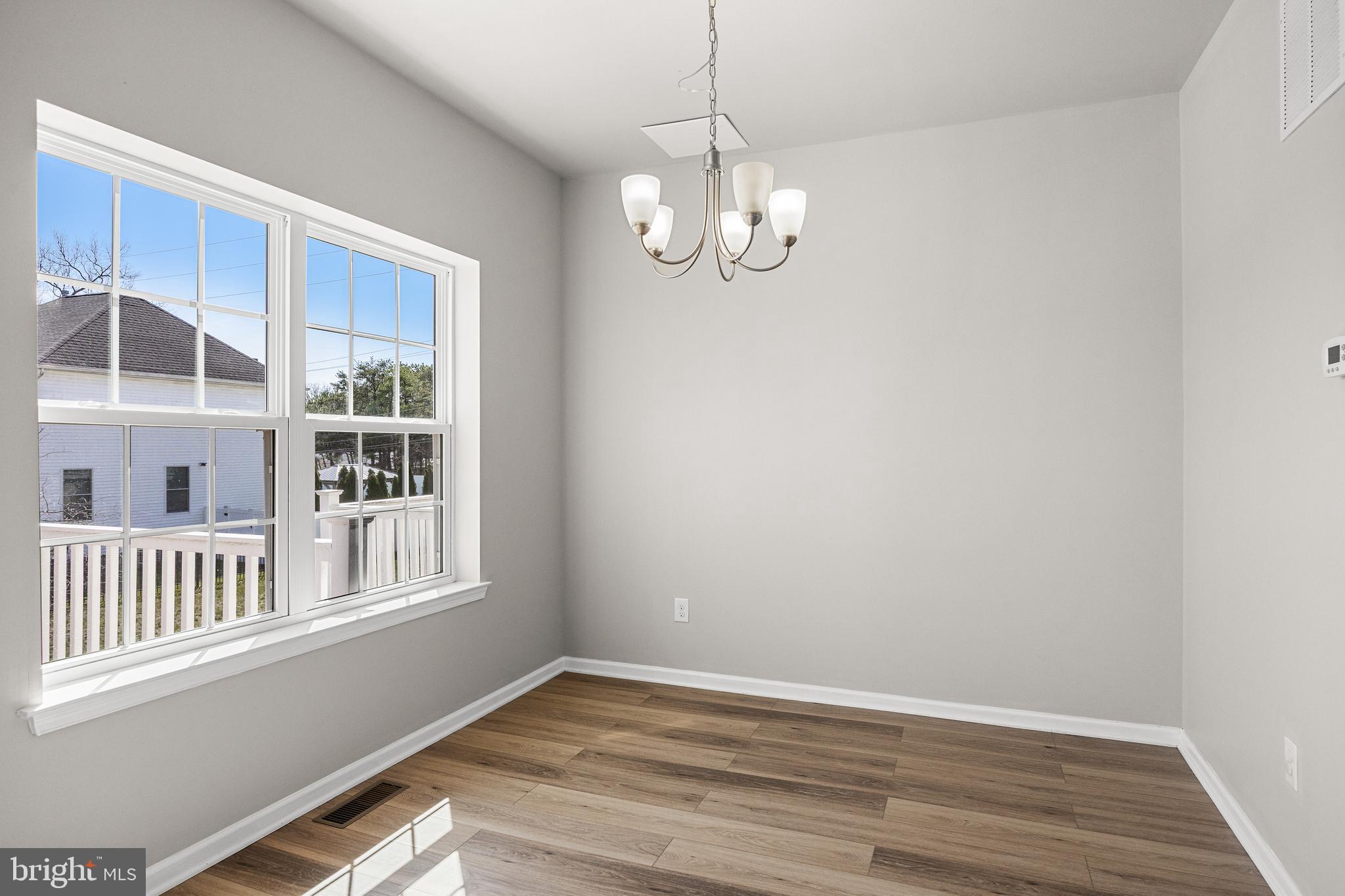 13 Iron Gate Road Sicklerville, NJ 08081 - Photo 16 of 25 a view of an empty room with wooden floor and windows