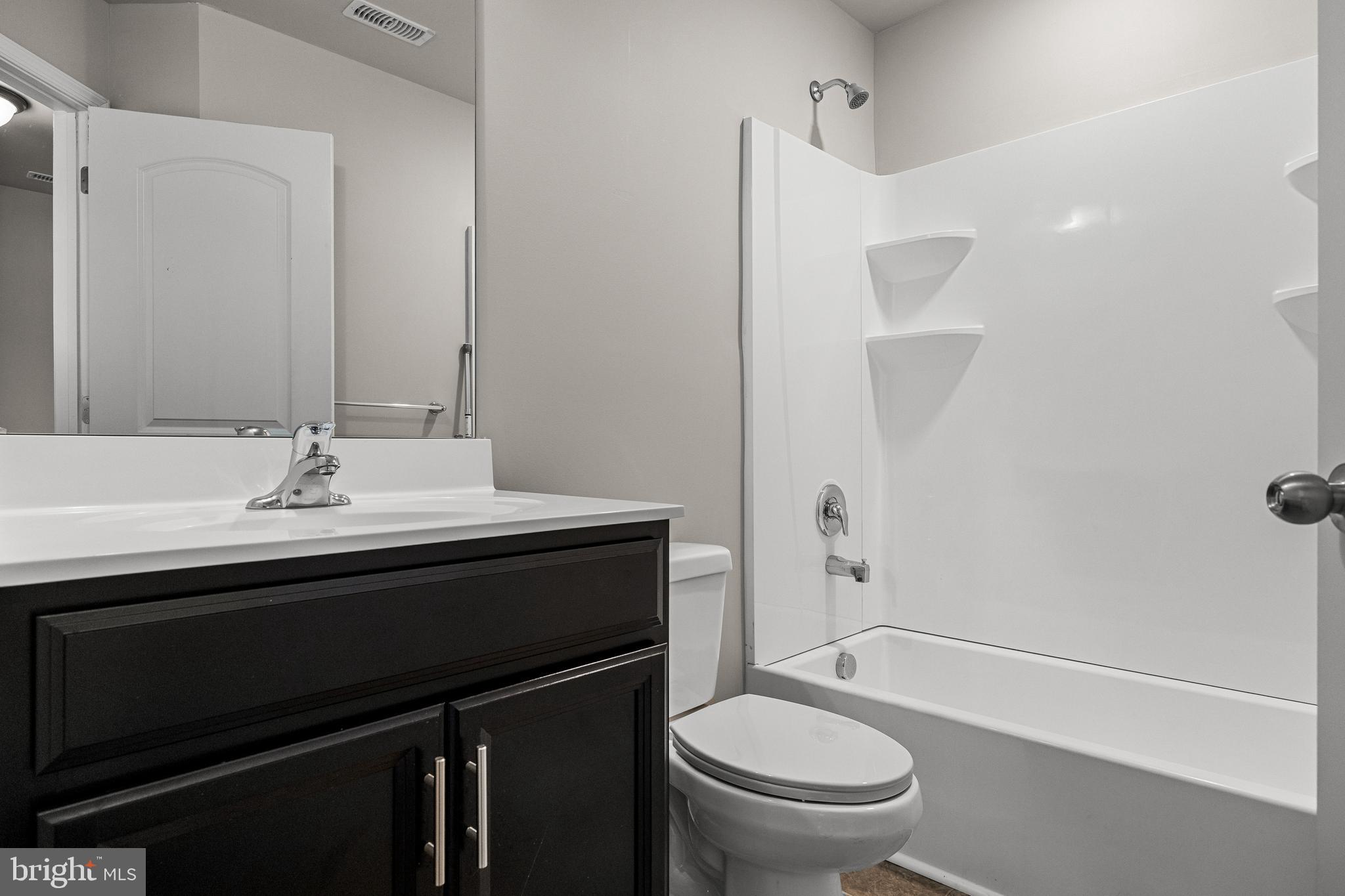13 Iron Gate Road Sicklerville, NJ 08081 - Photo 20 of 25 a bathroom with a sink a toilet and shower