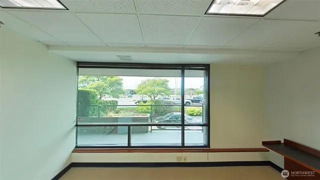 a view of a room that has a bed and a window