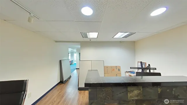 a view of a living room with furniture and wooden floor