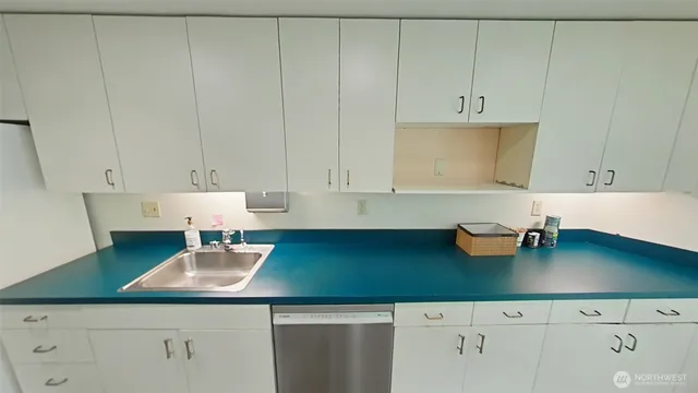 a kitchen with cabinets and window