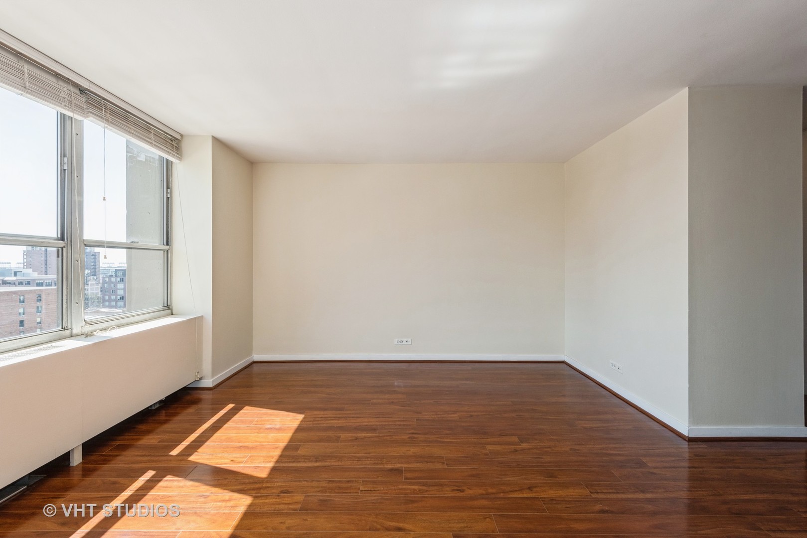 655 West Irving Park Road, Unit 1109 Chicago, IL 60613 - Photo 13 of 29 wooden floor in an empty room with a window