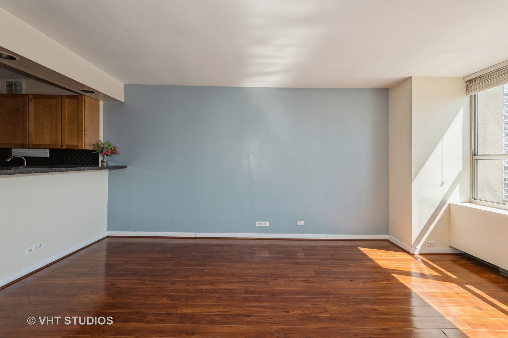 655 West Irving Park Road, Unit 1109 Chicago, IL 60613 - Photo 14 of 29 a view of an empty room with wooden floor and a window