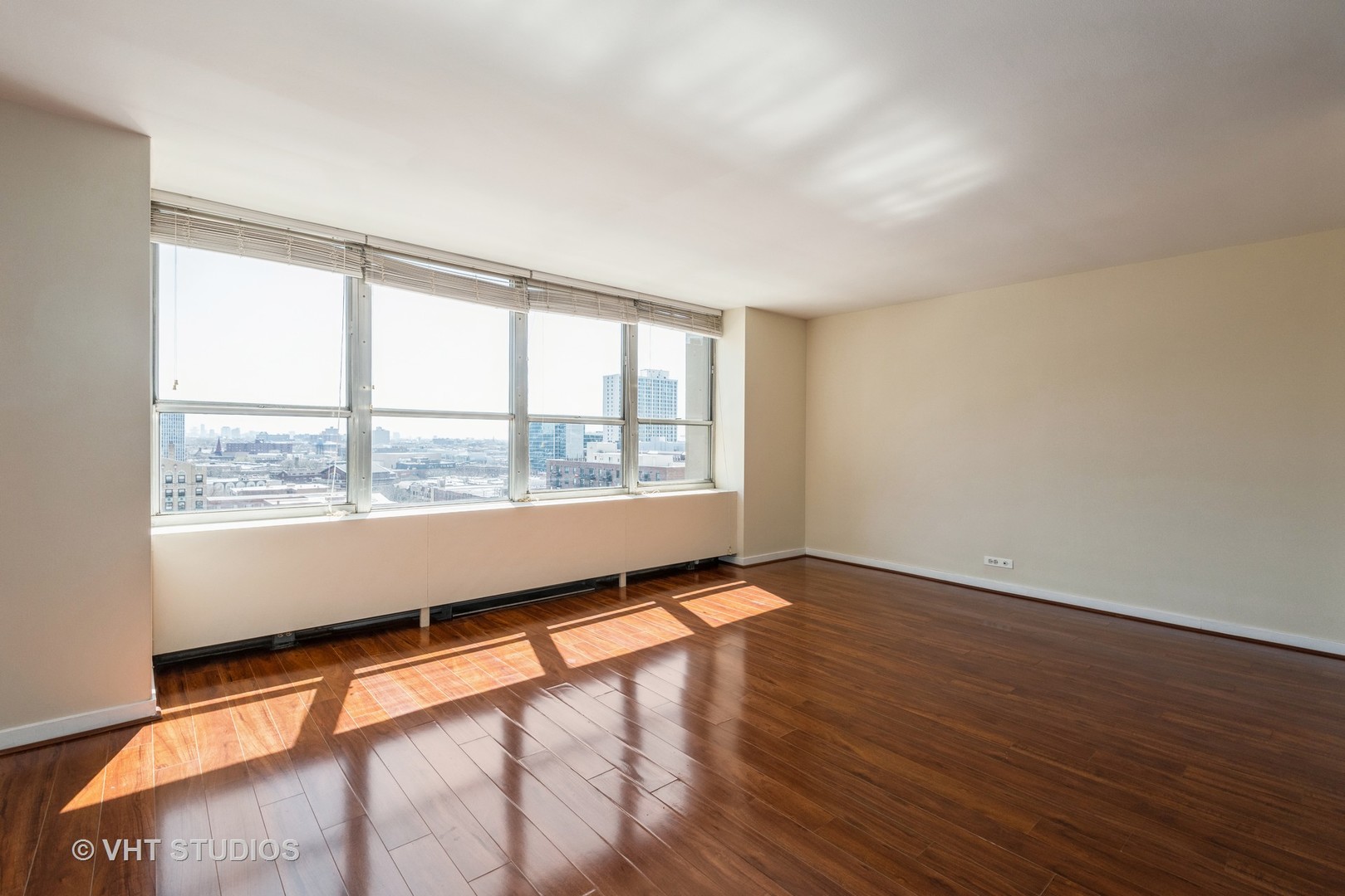 655 West Irving Park Road, Unit 1109 Chicago, IL 60613 - Photo 16 of 29 an empty room with wooden floor and windows