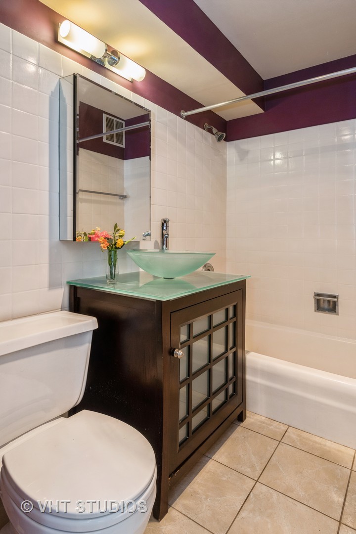 655 West Irving Park Road, Unit 1109 Chicago, IL 60613 - Photo 19 of 29 a bathroom with a sink a toilet and shower