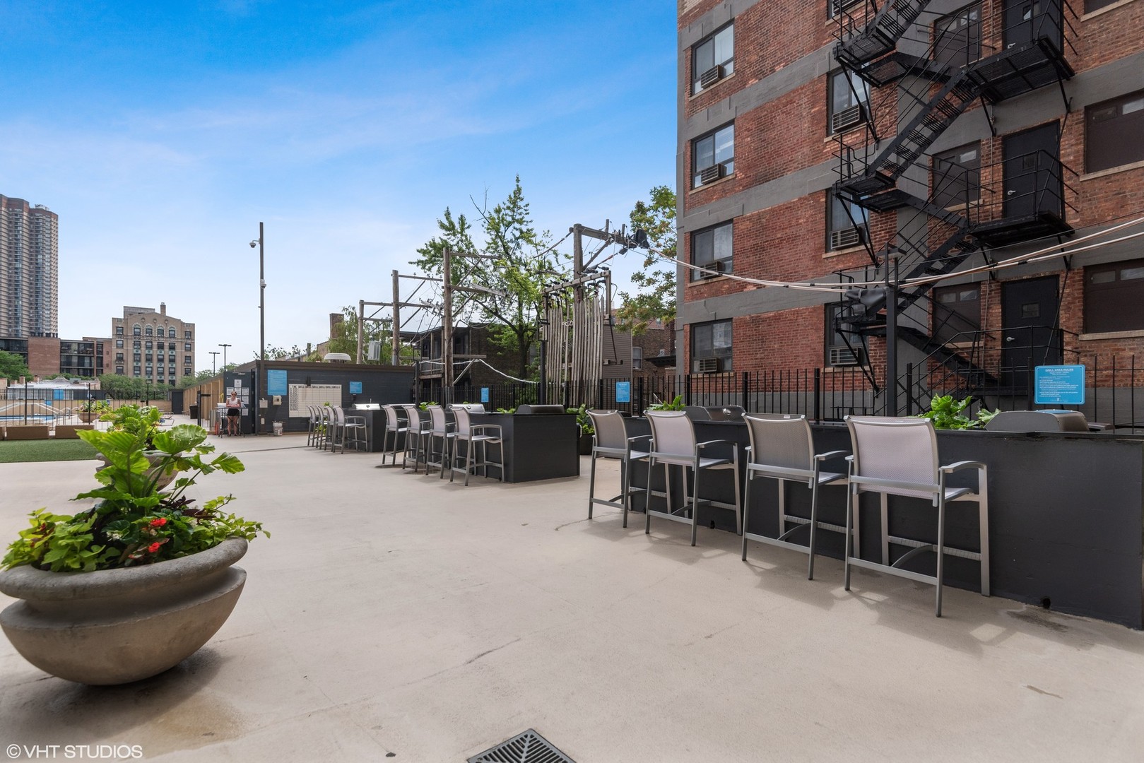 655 West Irving Park Road, Unit 1109 Chicago, IL 60613 - Photo 27 of 29 a view of a patio filled with furniture and a potted plant