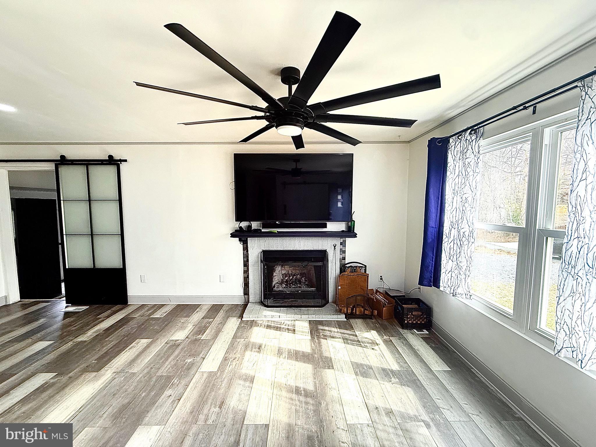 428 Buffalo Road Lusby, MD 20657 - Photo 10 of 20 a living room with furniture a fireplace and a flat screen tv